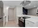 Open-concept kitchen features stainless appliances and connects seamlessly to living area and stairs at 3355 S Flower St # 166, Lakewood, CO 80227