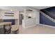 Open-concept living room with modern shelving, a staircase, and sleek, neutral flooring at 3355 S Flower St # 166, Lakewood, CO 80227