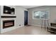 Bright living room boasts a modern fireplace, a front door, and great natural light at 3355 S Flower St # 166, Lakewood, CO 80227