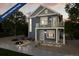 Two-story craftsman style home with gray siding, balcony, and landscaping at 13543 E 103Rd Ave, Commerce City, CO 80022