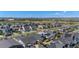 An aerial view of a suburban neighborhood, showcasing modern homes with solar panels and views of the Rocky Mountains at 10179 E 59Th North Pl, Denver, CO 80238