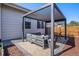 Outdoor living space featuring a pergola with stone pavers and comfortable seating at 10179 E 59Th North Pl, Denver, CO 80238