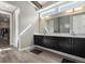 Bathroom featuring double vanity, plenty of cabinet space, and large mirror at 10179 E 59Th North Pl, Denver, CO 80238
