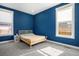 Bedroom with a light-wood frame bed and two windows providing natural light at 10179 E 59Th North Pl, Denver, CO 80238