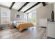 Cozy bedroom featuring a large window, wood floors, and modern decor for a relaxing atmosphere at 10179 E 59Th North Pl, Denver, CO 80238