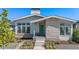 Charming home exterior with stone accents, landscaped garden, and a bright green front door at 10179 E 59Th North Pl, Denver, CO 80238