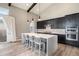 Modern kitchen with sleek cabinets, large island with seating, and stainless steel appliances at 10179 E 59Th North Pl, Denver, CO 80238