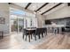 Bright kitchen and dining area with modern lighting, spacious island, and sliding glass doors to outdoor space at 10179 E 59Th North Pl, Denver, CO 80238