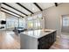 Open-concept kitchen and living room with island, modern appliances, dining area, and large windows for a bright space at 10179 E 59Th North Pl, Denver, CO 80238