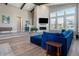 Open living room with fireplace, vaulted ceiling, wood floors and comfortable, modern furniture at 10179 E 59Th North Pl, Denver, CO 80238