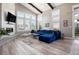 Bright living room with vaulted ceiling, large windows, modern fireplace, and stylish furnishings at 10179 E 59Th North Pl, Denver, CO 80238