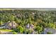 Aerial view of home featuring lush green trees surrounding the property and other homes at 5159 Serene View Way, Parker, CO 80134