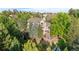 Gorgeous home surrounded by a green yard with an outdoor patio and hot tub at 5159 Serene View Way, Parker, CO 80134