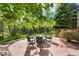 Backyard stone patio with comfortable seating surrounding a gas fire pit at 5159 Serene View Way, Parker, CO 80134