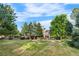 Expansive backyard lawn with mature trees creating a serene park-like setting at 5159 Serene View Way, Parker, CO 80134