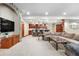 Finished basement featuring a large sectional, stone archway, and custom wet bar with bar seating at 5159 Serene View Way, Parker, CO 80134