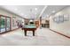Finished basement with billiards table, stone fireplace and wet bar perfect for entertaining guests at 5159 Serene View Way, Parker, CO 80134
