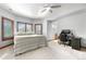 Bright bedroom with a ceiling fan, large windows and a dedicated desk and workstation area at 5159 Serene View Way, Parker, CO 80134