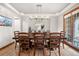 Bright dining room features a chandelier, large table with seating for ten, and hardwood floors at 5159 Serene View Way, Parker, CO 80134