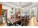 Dining room features an elegant chandelier, large table with seating for eight, and hardwood floors at 5159 Serene View Way, Parker, CO 80134