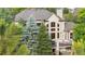 Exterior elevation featuring lush green trees surrounding the property with a back deck at 5159 Serene View Way, Parker, CO 80134