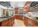 Well-equipped kitchen boasts wood cabinets, stainless appliances, granite counters, and breakfast nook at 5159 Serene View Way, Parker, CO 80134