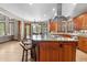 Gourmet kitchen with granite island, breakfast bar, stainless hood, and eat-in dining area at 5159 Serene View Way, Parker, CO 80134