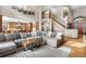 Spacious living room featuring a large sectional sofa, open to the kitchen area at 5159 Serene View Way, Parker, CO 80134