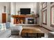 Cozy living room with a stone fireplace, custom mantel, and large windows at 5159 Serene View Way, Parker, CO 80134