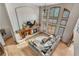 Bright living room with a stone fireplace, tall ceilings, and walls of windows at 5159 Serene View Way, Parker, CO 80134