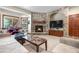 Cozy living room features a stone fireplace, built-in cabinets, and large windows at 5159 Serene View Way, Parker, CO 80134