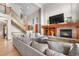 Elegant living room featuring a cozy fireplace, high ceilings, and staircase at 5159 Serene View Way, Parker, CO 80134