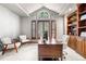 Bright office featuring built-in bookcase, vaulted ceilings, large window, and neutral carpet at 5159 Serene View Way, Parker, CO 80134