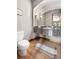 Cozy powder room features granite vanity, undermount sink, decorative mirror, and hardwood floors at 5159 Serene View Way, Parker, CO 80134