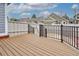 Wood deck with black metal railing offering a private outdoor space with a fenced backyard at 1518 Whitehall Dr, Longmont, CO 80504