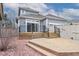 Backyard view with deck, patio area, and landscaped features at 1518 Whitehall Dr, Longmont, CO 80504