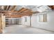 Spacious unfinished basement with exposed ceiling and metal shelving, ideal for customization or ample storage space at 1518 Whitehall Dr, Longmont, CO 80504