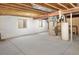 Unfinished basement with concrete floor, white walls, and exposed ceiling, ready for customization and storage at 1518 Whitehall Dr, Longmont, CO 80504