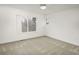 Carpeted bedroom with a large window providing natural light and a ceiling fan at 1518 Whitehall Dr, Longmont, CO 80504