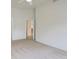 Spacious bedroom with neutral walls and carpets, ceiling fan, and open doorway at 1518 Whitehall Dr, Longmont, CO 80504