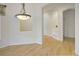 Dining room featuring hardwood floors, decorative lighting, and arched doorways at 1518 Whitehall Dr, Longmont, CO 80504
