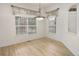 Bright dining area with light hardwood floors, large windows, and stylish chandelier at 1518 Whitehall Dr, Longmont, CO 80504