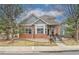 Charming home with brick and siding, complemented by mature trees and landscaping at 1518 Whitehall Dr, Longmont, CO 80504