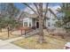 Charming two-story home with a bay window, brick accents, mature trees, and a welcoming front entrance at 1518 Whitehall Dr, Longmont, CO 80504