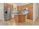 Kitchen boasts stainless steel refrigerator, hardwood flooring and a functional island at 1518 Whitehall Dr, Longmont, CO 80504