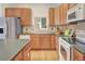 Kitchen with wood cabinets, tile backsplash, and stainless steel appliances at 1518 Whitehall Dr, Longmont, CO 80504