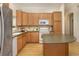 Well-lit kitchen featuring hardwood floors, cabinets, and modern appliances at 1518 Whitehall Dr, Longmont, CO 80504