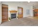 Cozy living room with fireplace, built-in shelves, and bright window at 1518 Whitehall Dr, Longmont, CO 80504