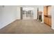 Spacious living room with fireplace and access to the outdoor deck through sliding doors at 1518 Whitehall Dr, Longmont, CO 80504