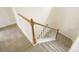 Carpeted stairs with white railings and wooden posts, connecting floors at 1518 Whitehall Dr, Longmont, CO 80504
